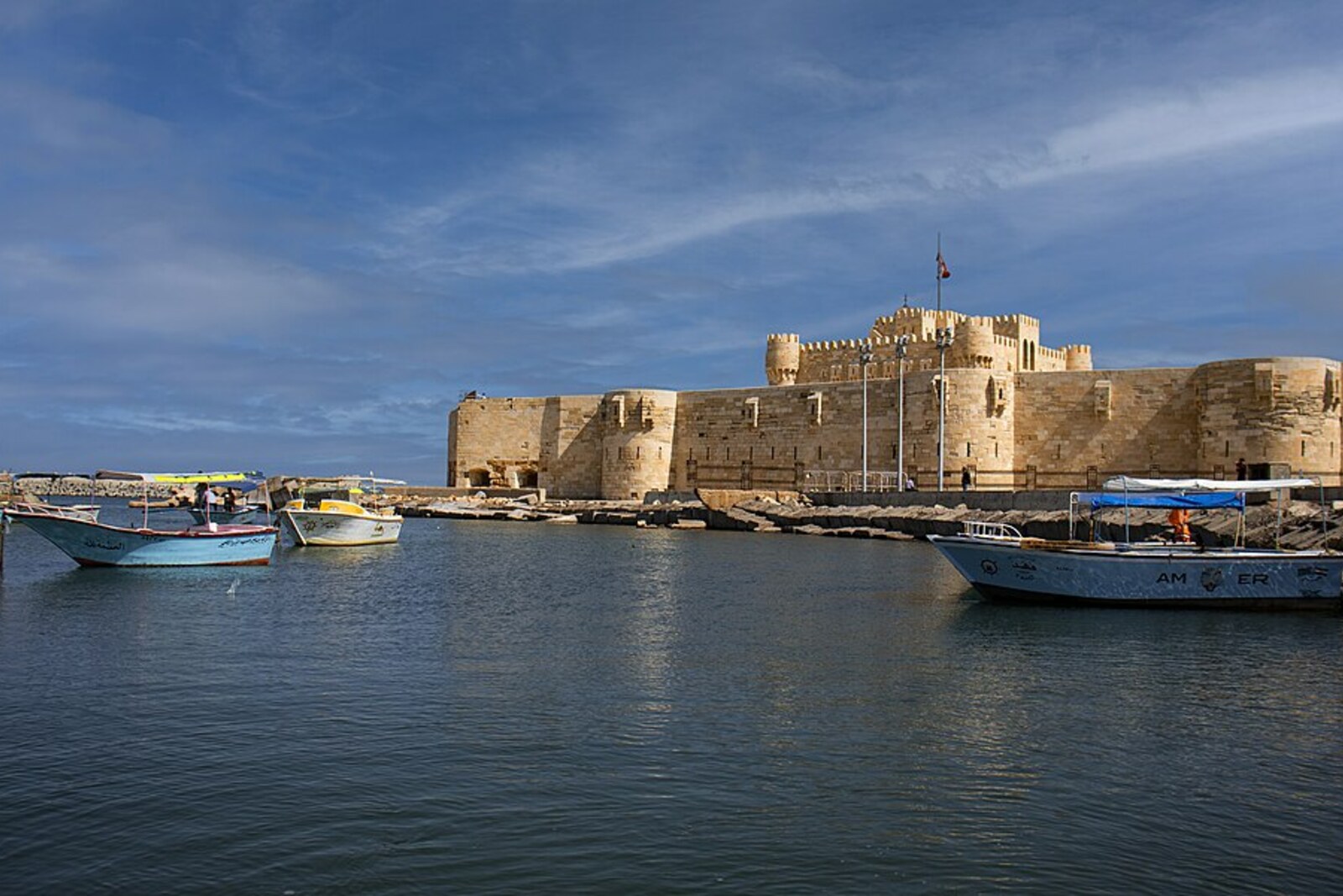 Fishing boats in Anfushi with Qaitbay Citadel behind them.