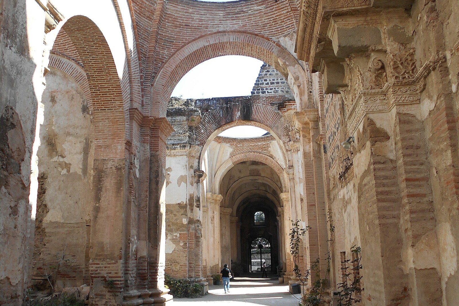 Brick arches and supports of the cathedral ruins, open to the blue sky