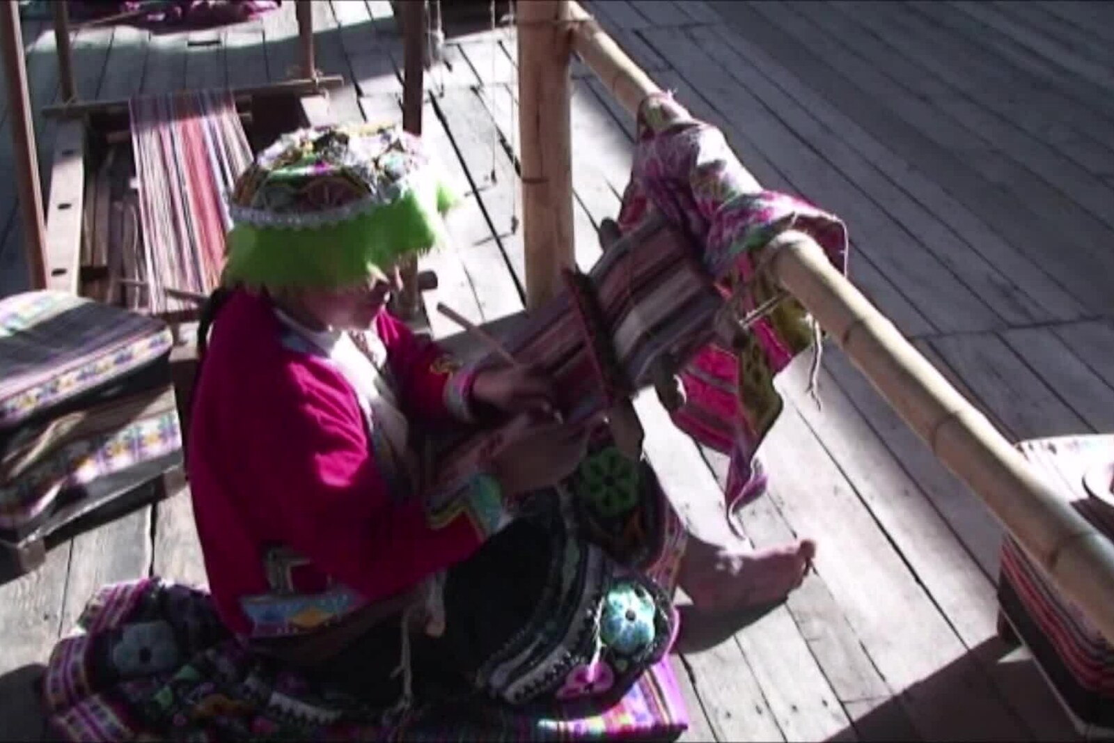 A craftswoman works on a backstrap loom at an Arequipa alpaca-fiber processing site