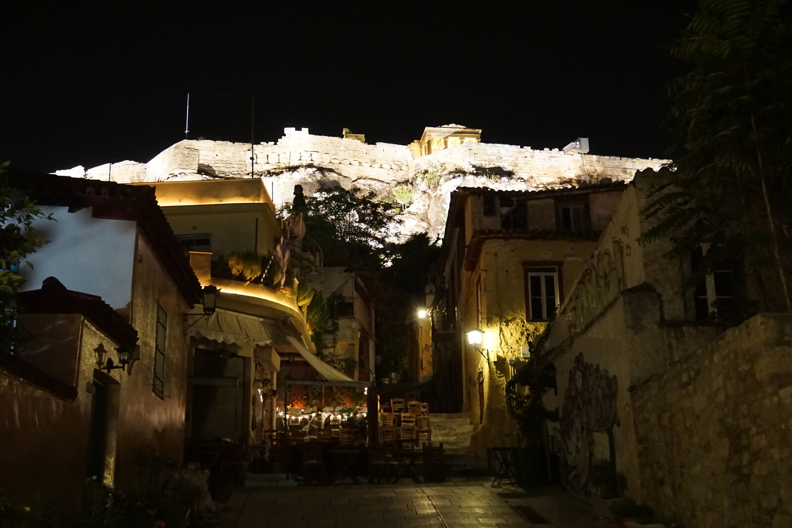 White cubic houses of Anafiotika on a slope overlooking the Acropolis of Athens