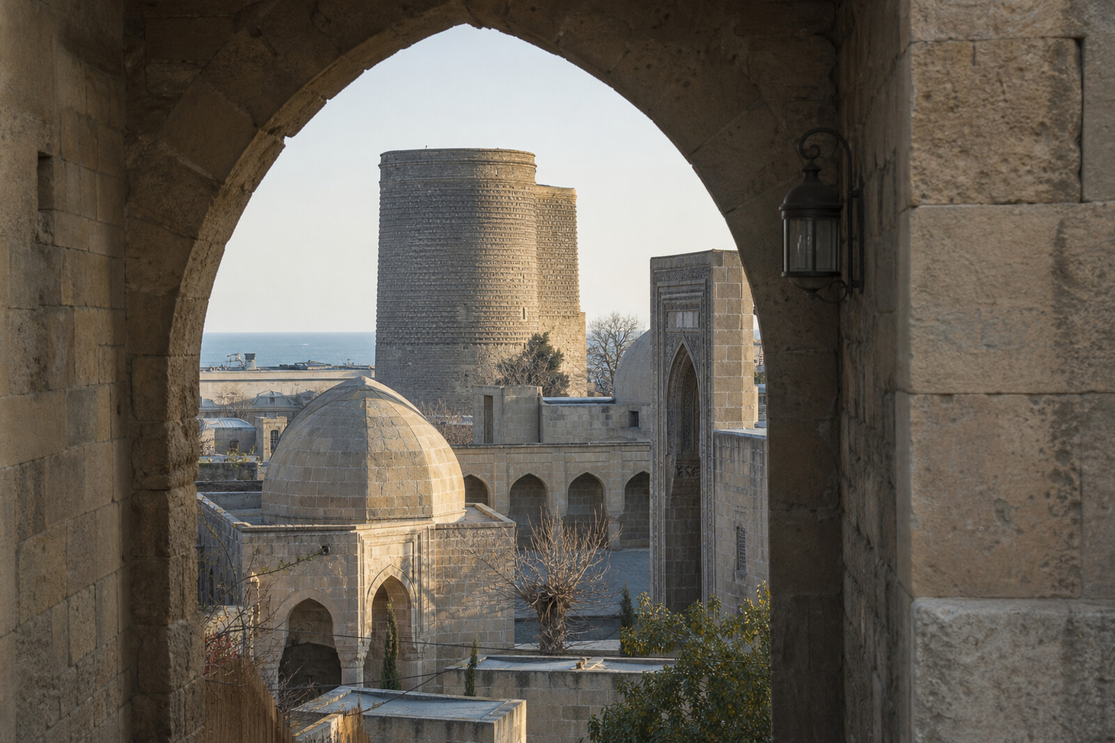 The stone gates of Icherisheher lead toward Maiden Tower, a caravanserai, and a palace by the former Caspian Sea shoreline.
