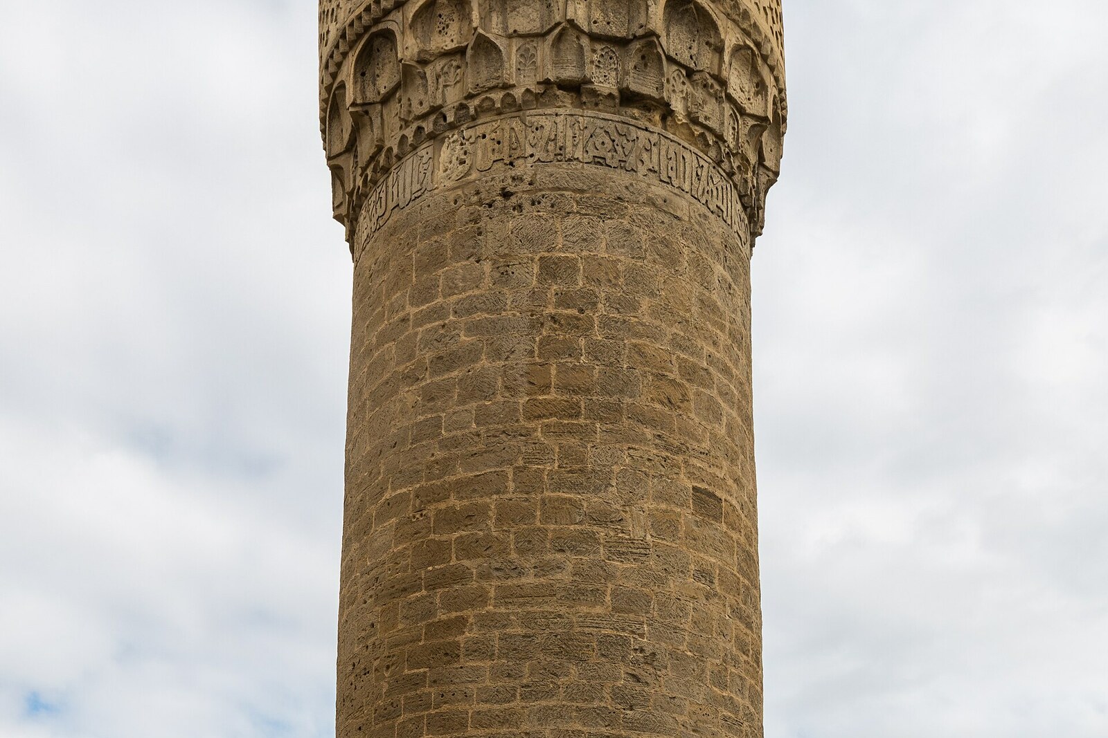 The stone Muhammad Mosque and its cylindrical minaret.