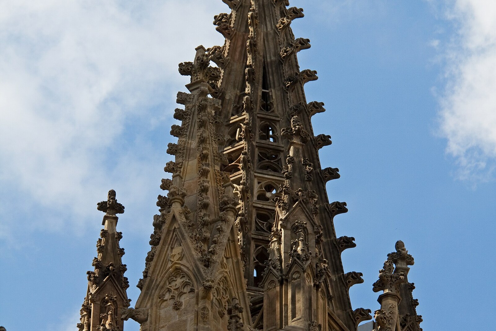 Gothic façade of the cathedral with two towers and a rose window in Barcelona