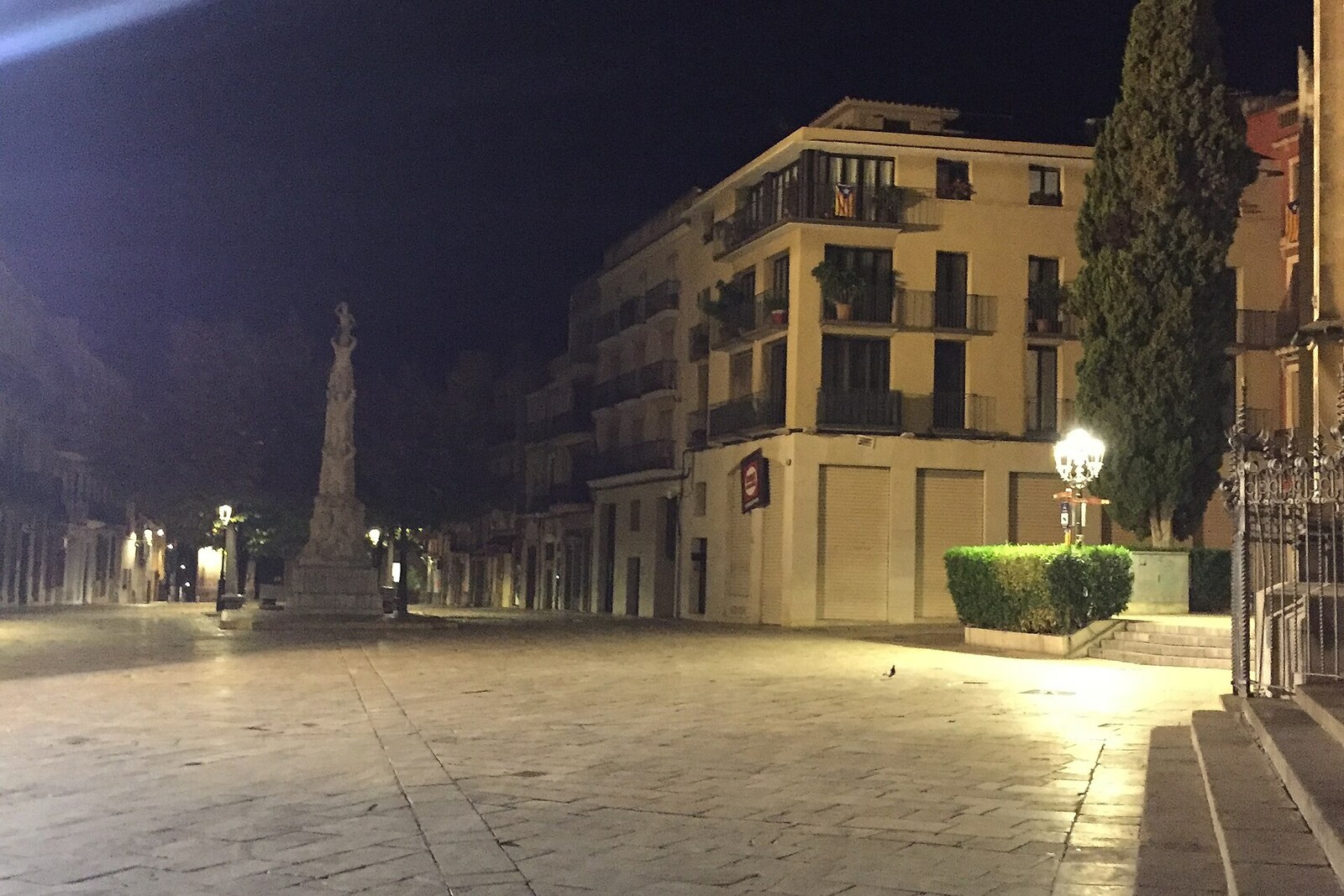 A large square in Barcelona with historic government buildings and city hall