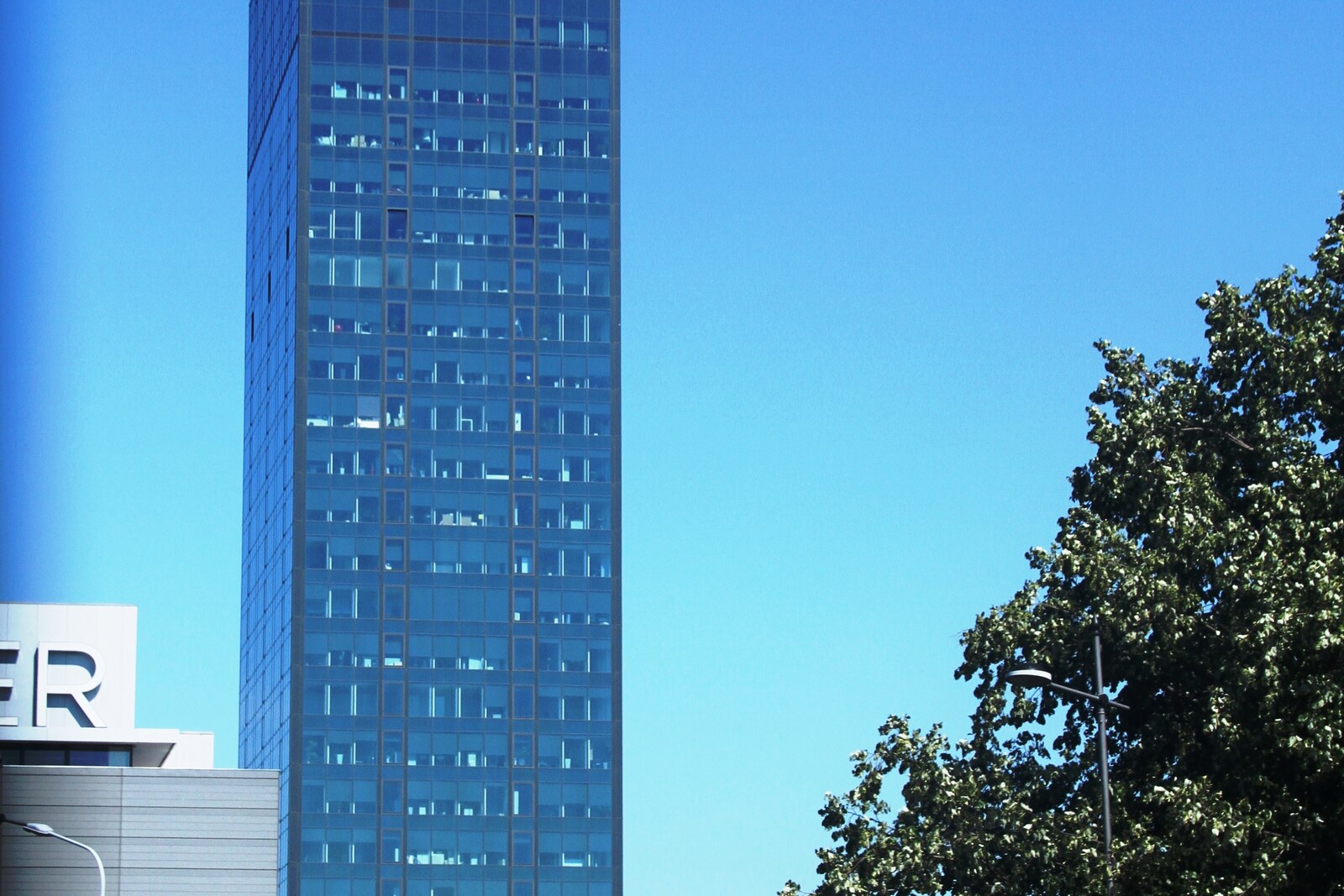 Tall modernist Ušće Tower with bands of glass
