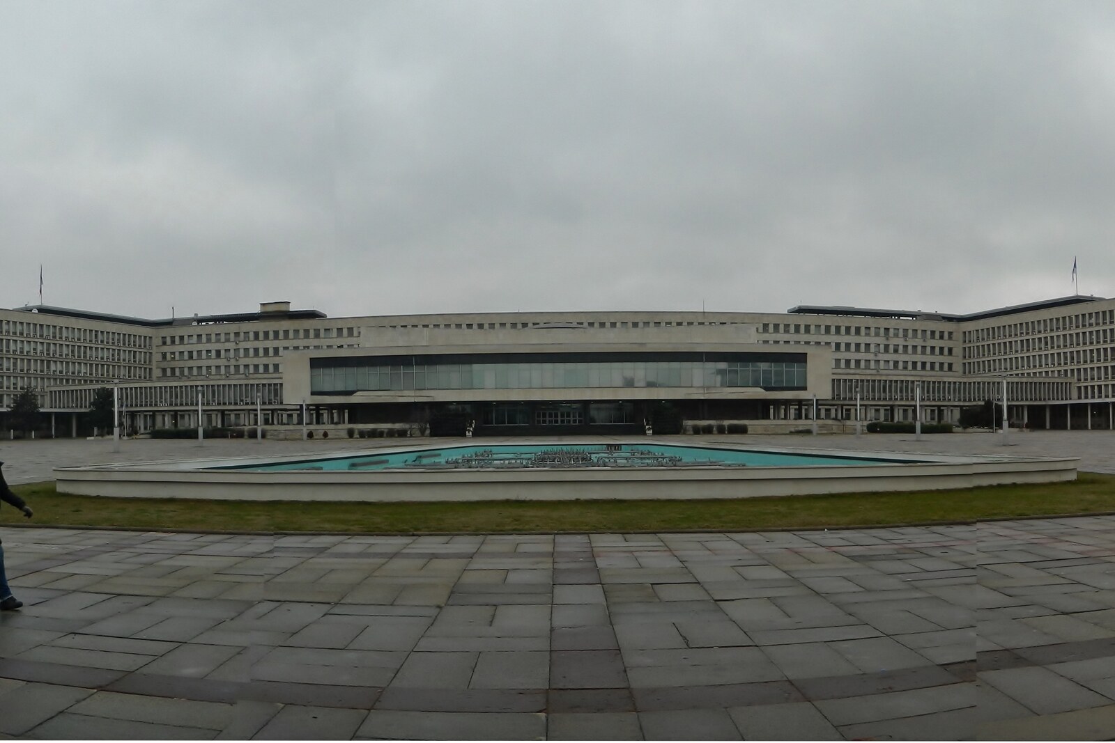 The long white facade of the Palace of Serbia with flags