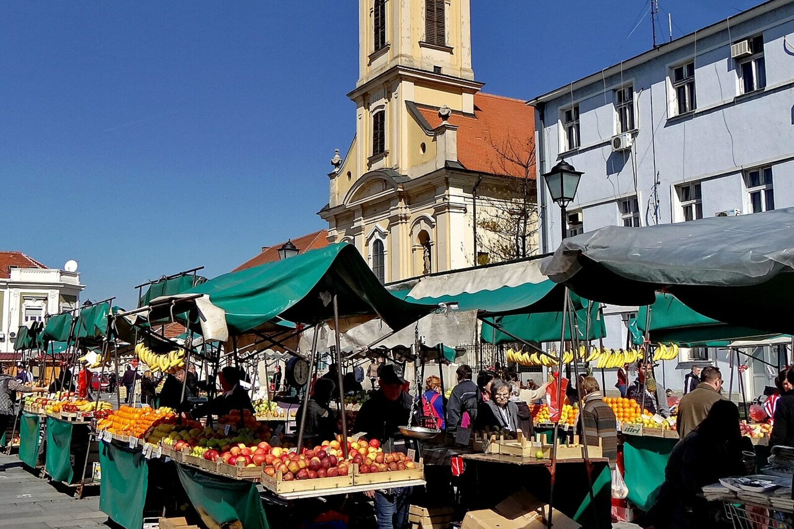 Pedestrian square with historic buildings and cafés.