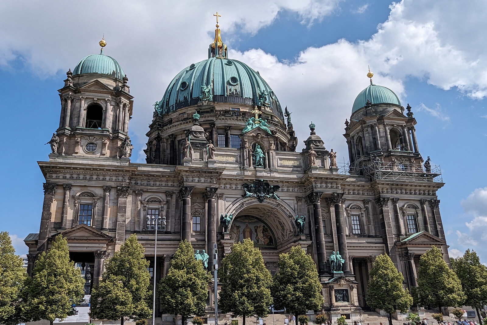 The façade of Berlin Cathedral with its green dome and sculptures