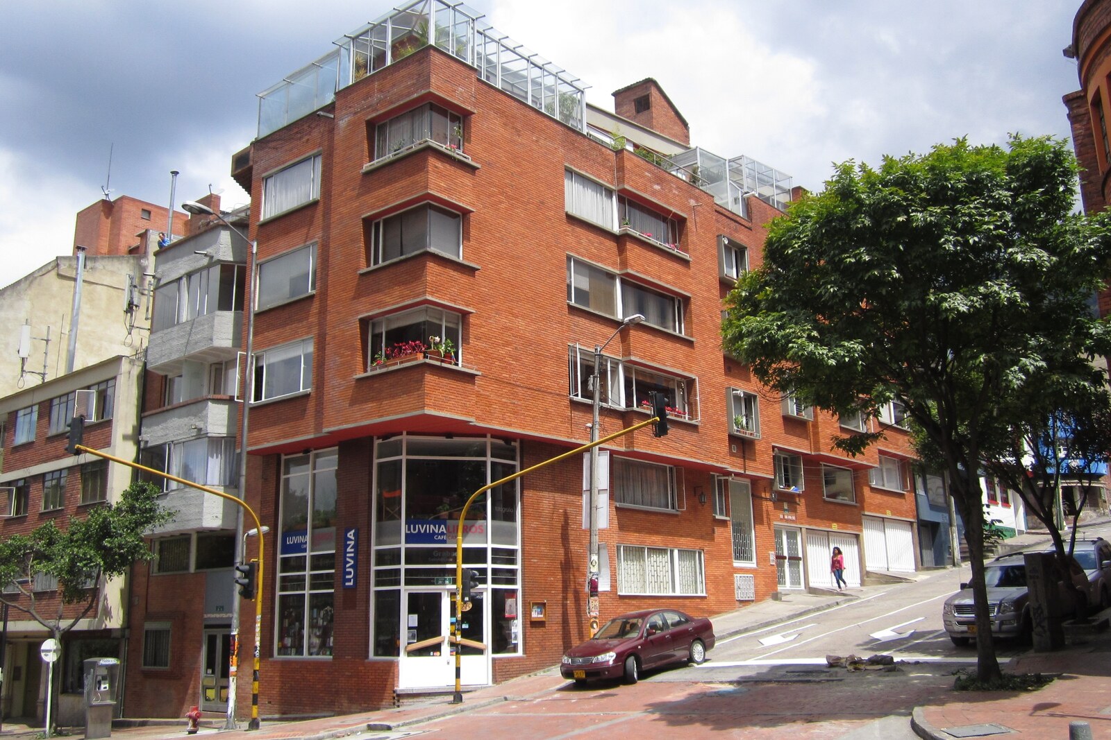 A brick corner building and a narrow street in the La Macarena neighborhood