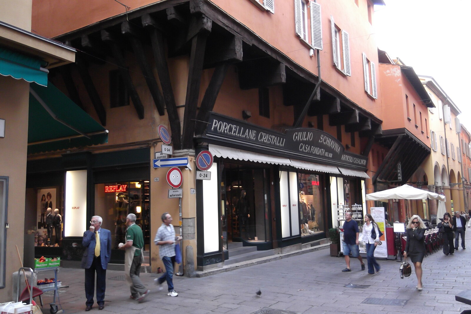 A narrow alley with colorful fruit and vegetable stalls