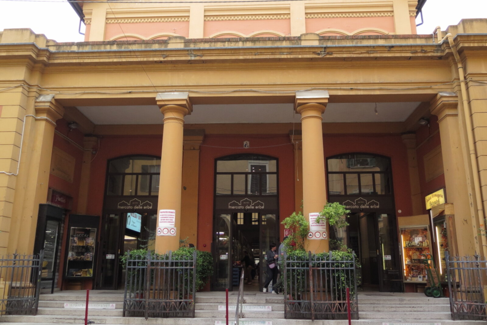 The Gothic facade of Palazzo della Mercanzia with a stone balcony and arches