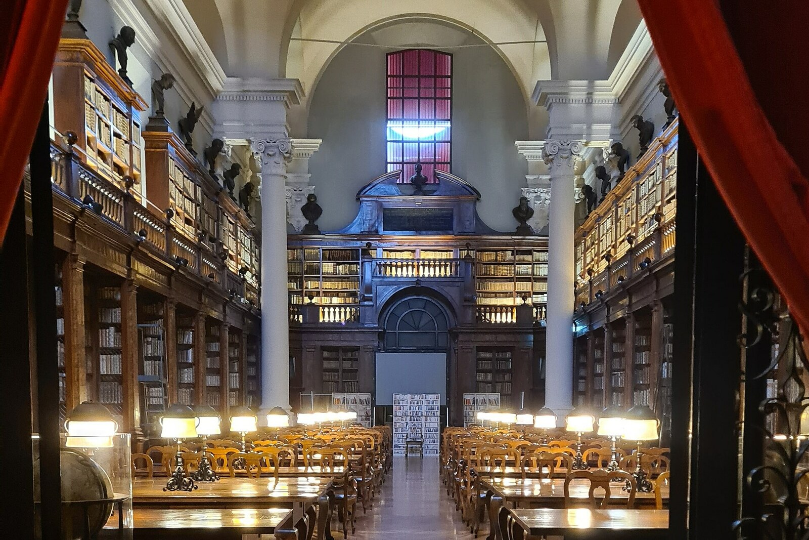 Frescoes and wooden shelves in the reading room of the University of Bologna