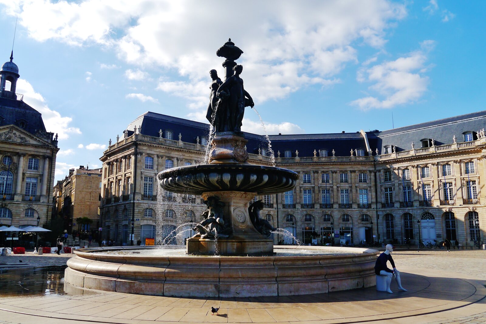 The facades of Place de la Bourse and the Three Graces Fountain in Bordeaux.