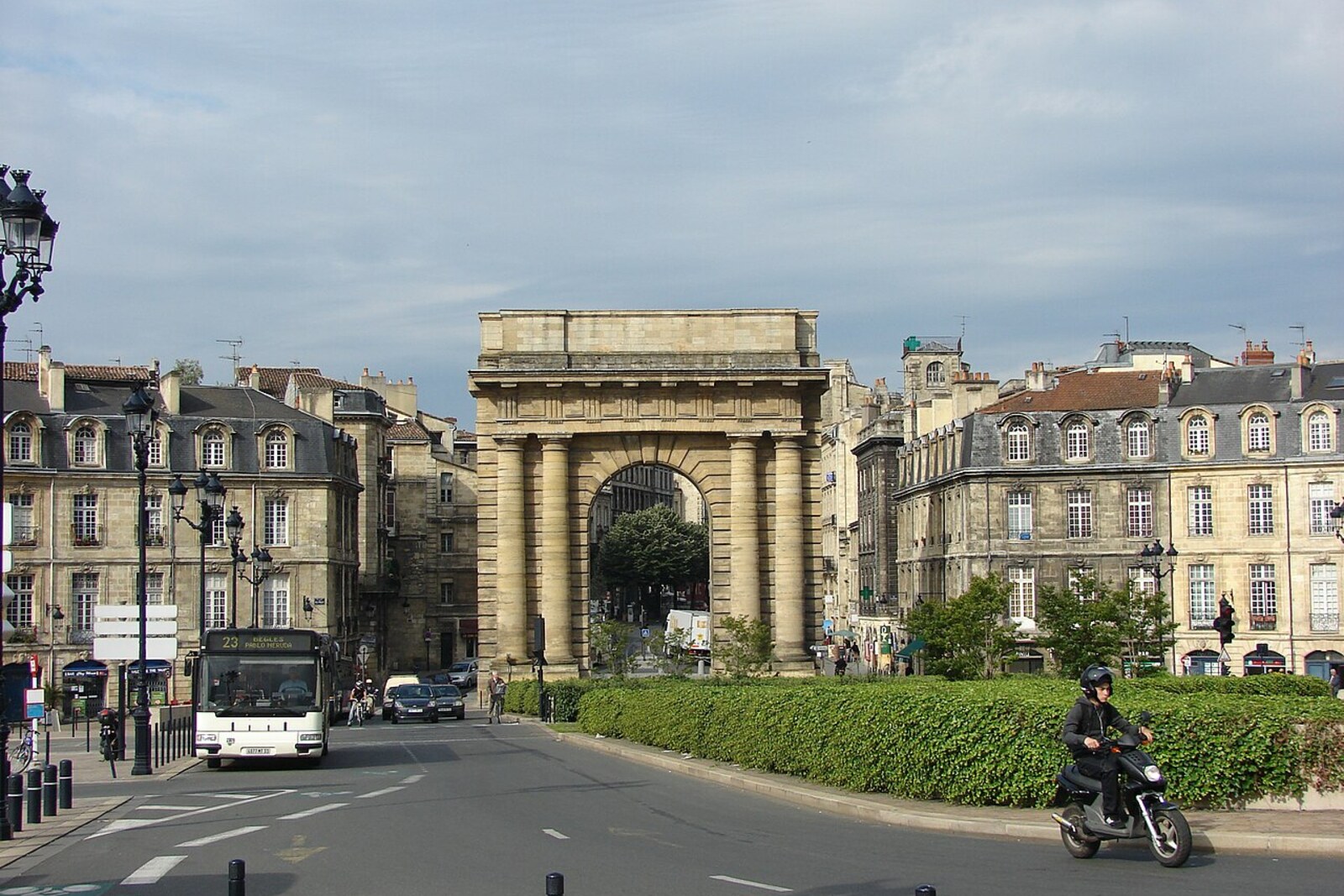 The Porte de Bourgogne arch with Doric columns against the backdrop of the street