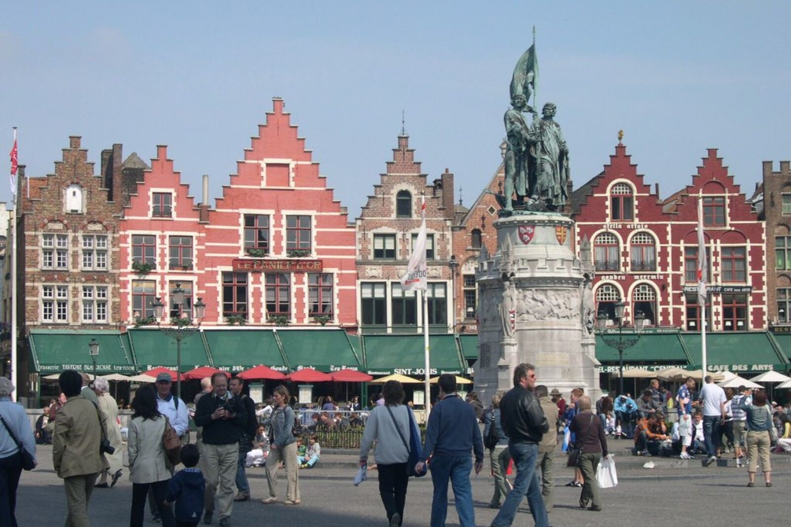Market Square in Bruges with historic facades and the tower of the Belfry of Bruges.