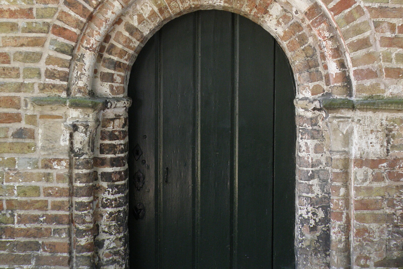 The façade of Saint Elizabeth's Church in the beguinage in Bruges, with white walls and a pointed window