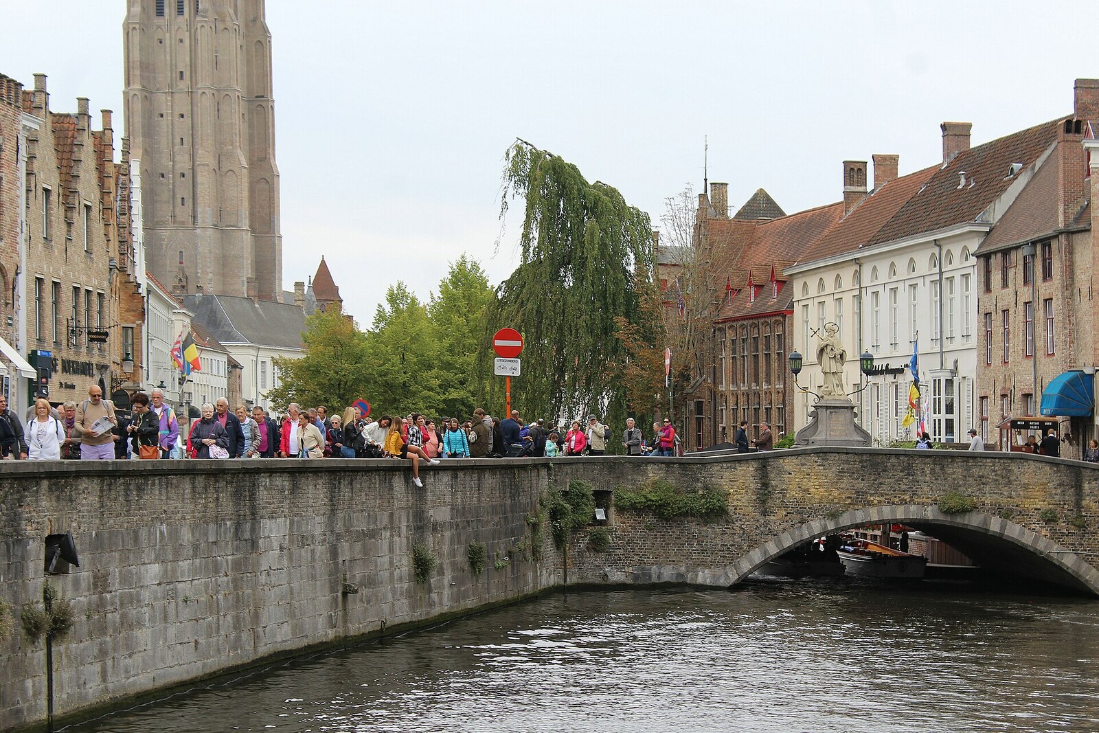 The Dijver canal in Bruges, with a bridge and the reflection of Gothic façades.