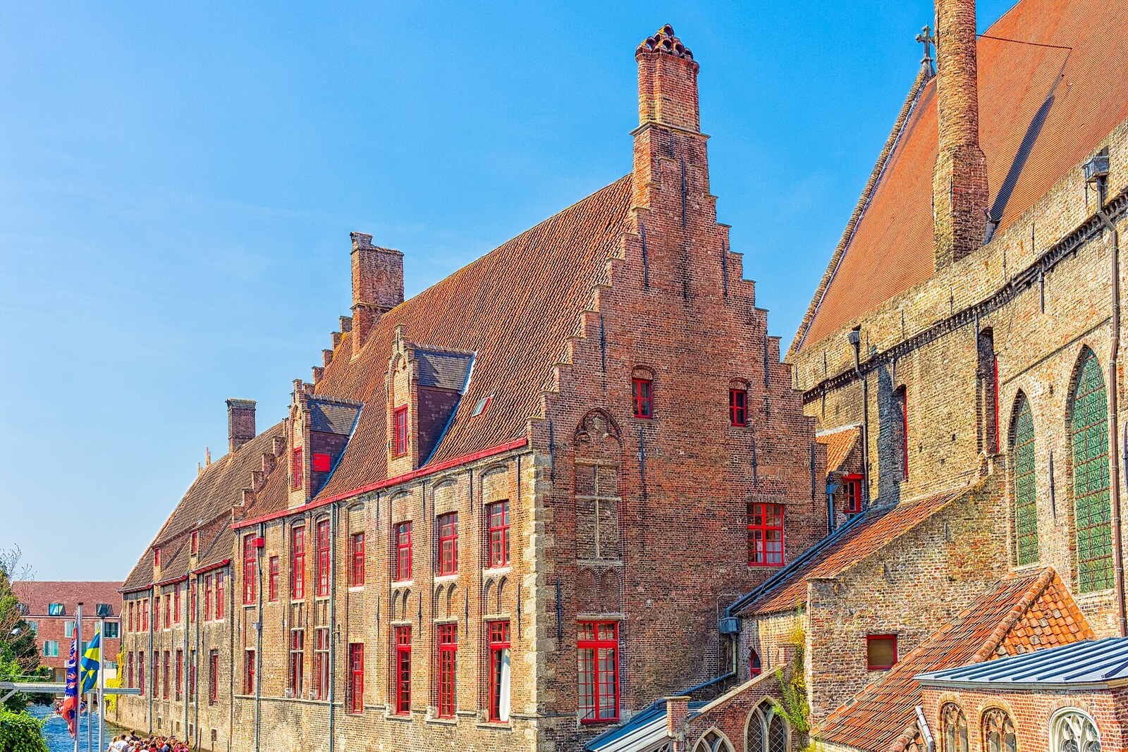 Red brick buildings of St John's Hospital with white windows.