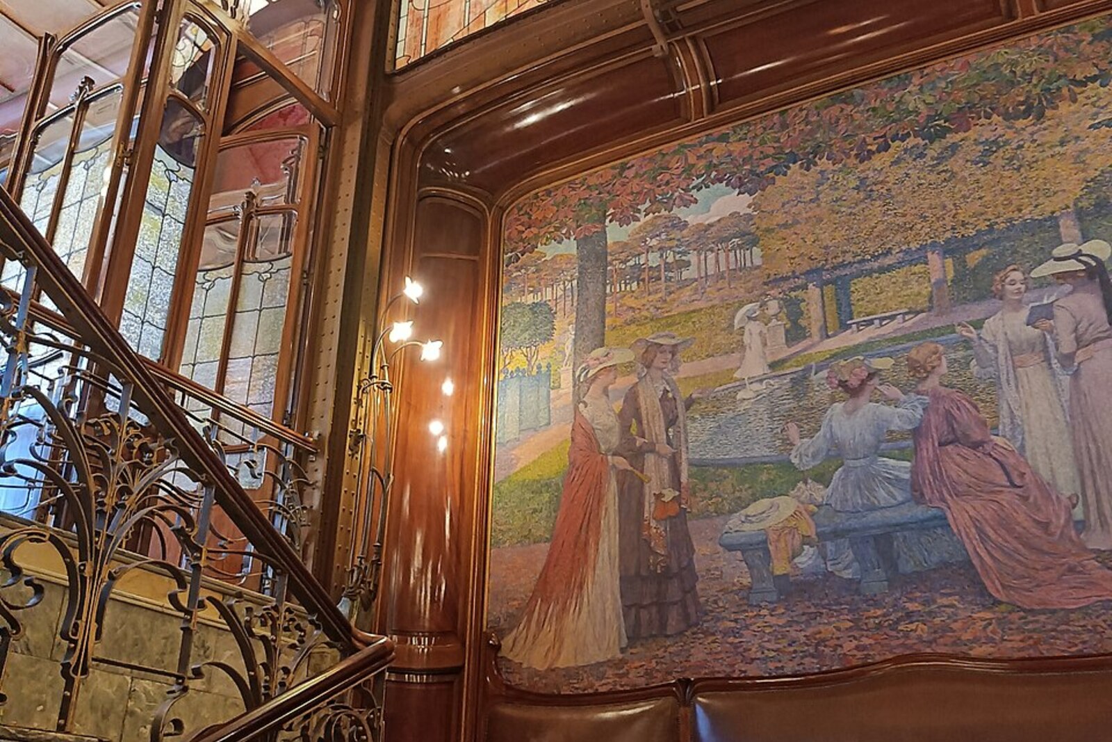 The grand staircase of Hôtel Solvay, with wrought metalwork and warm interior finishes.