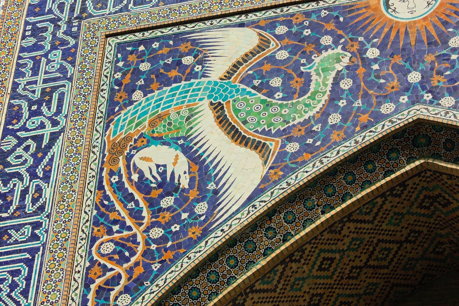 The mosaic portal of Nadir Divan-Begi Madrasah with mythical birds and deer.