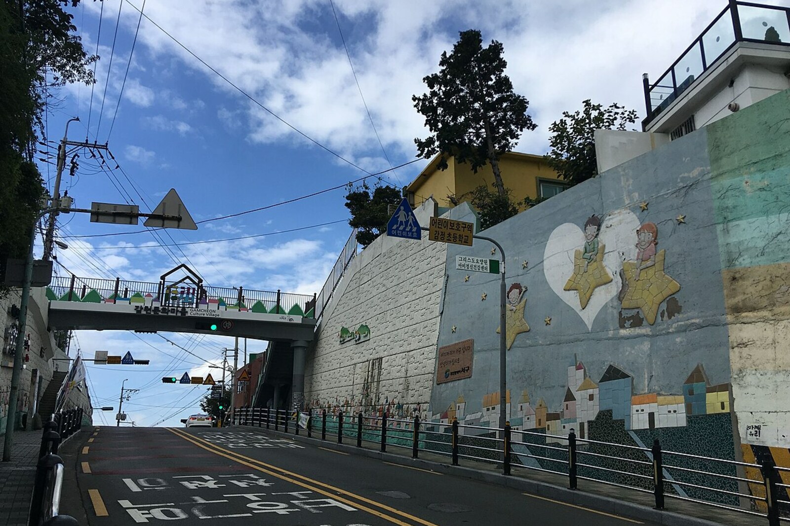 The entrance to Gamcheon Culture Village, with a colorful arrow and multicolored houses.