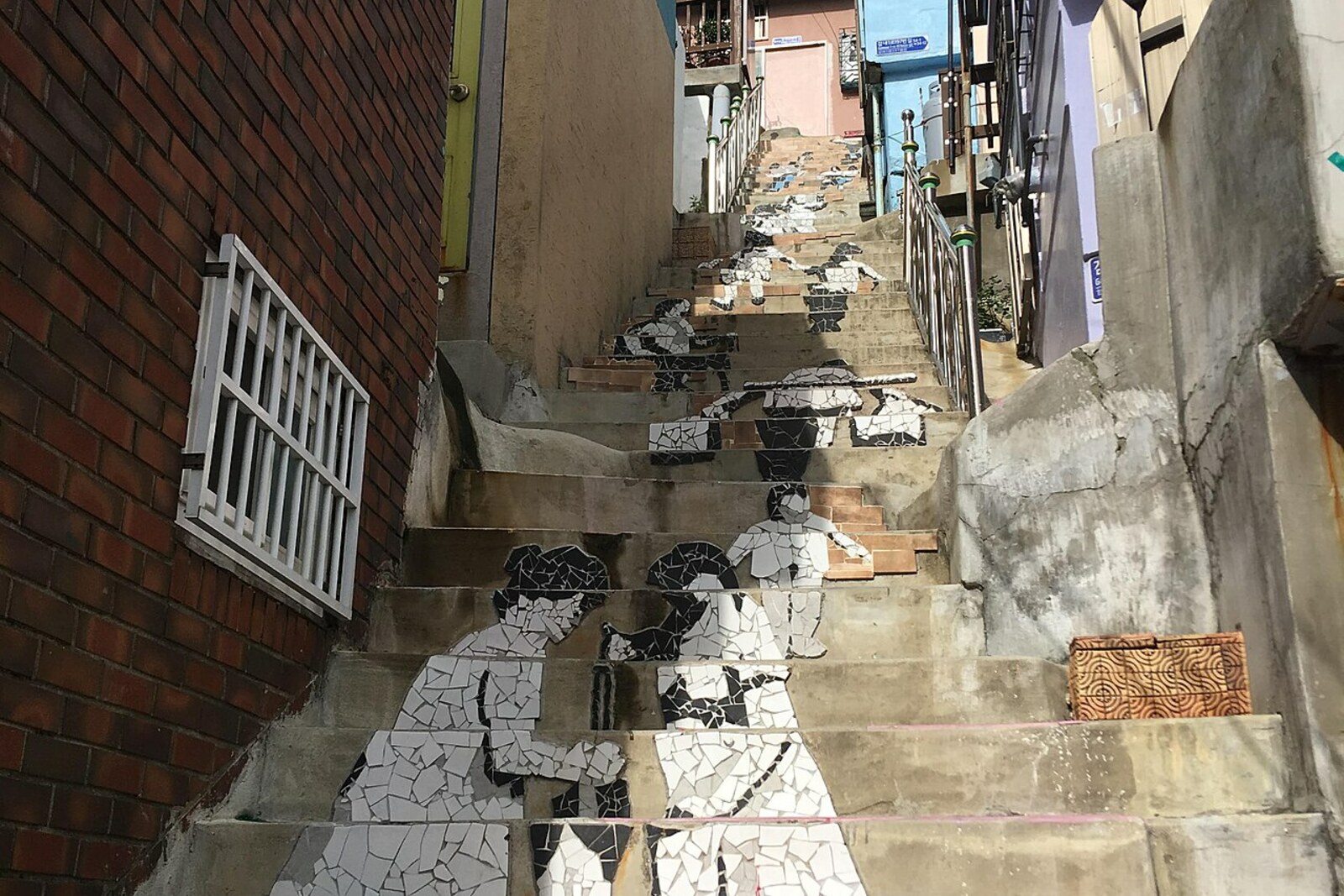 A long staircase with steps and mosaics in Gamcheon Culture Village.