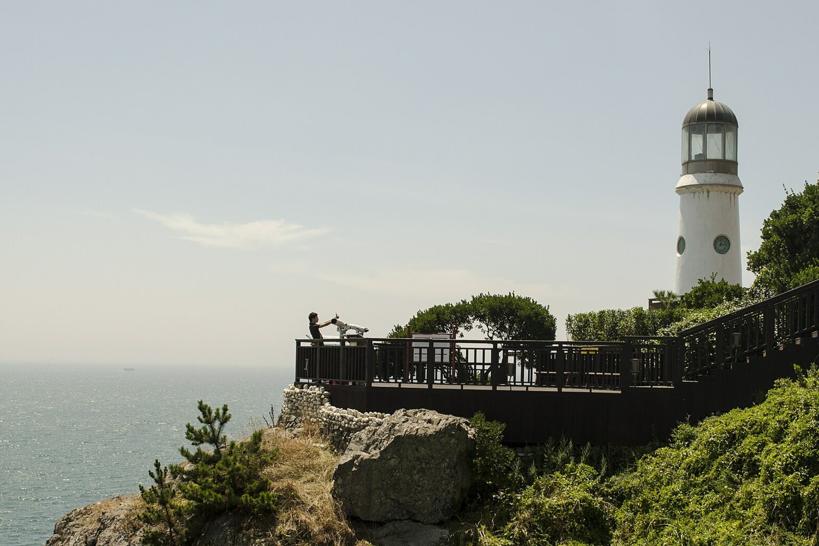 Viewpoint and lighthouse on the coast of Dongbaekseom Island beside the Princess Hwangok Mermaid Statue in Busan.