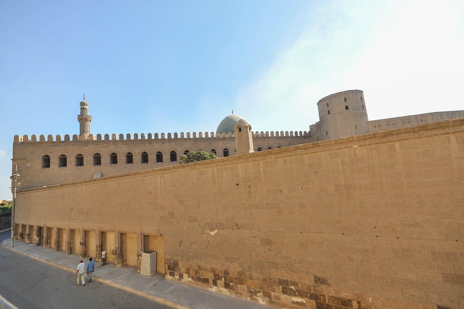 View of the massive walls of the Cairo Citadel, with towers and battlements.