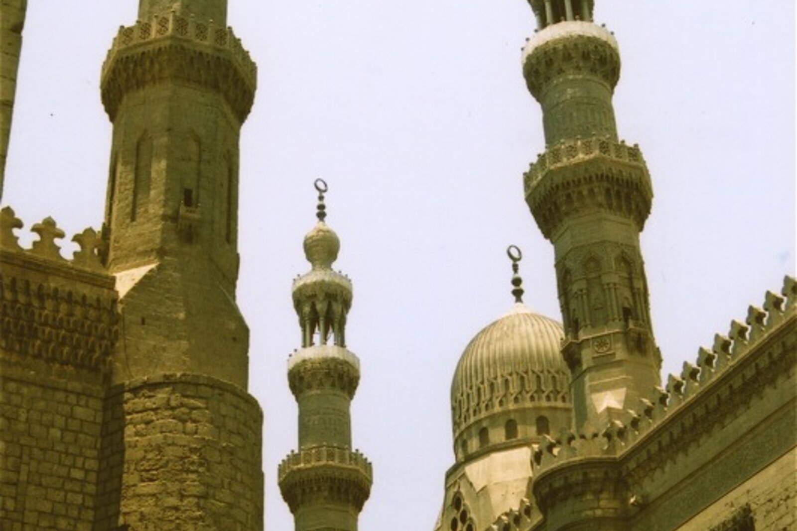 Tall minarets and the facade of the Mosque-Madrasa of Sultan Hassan.