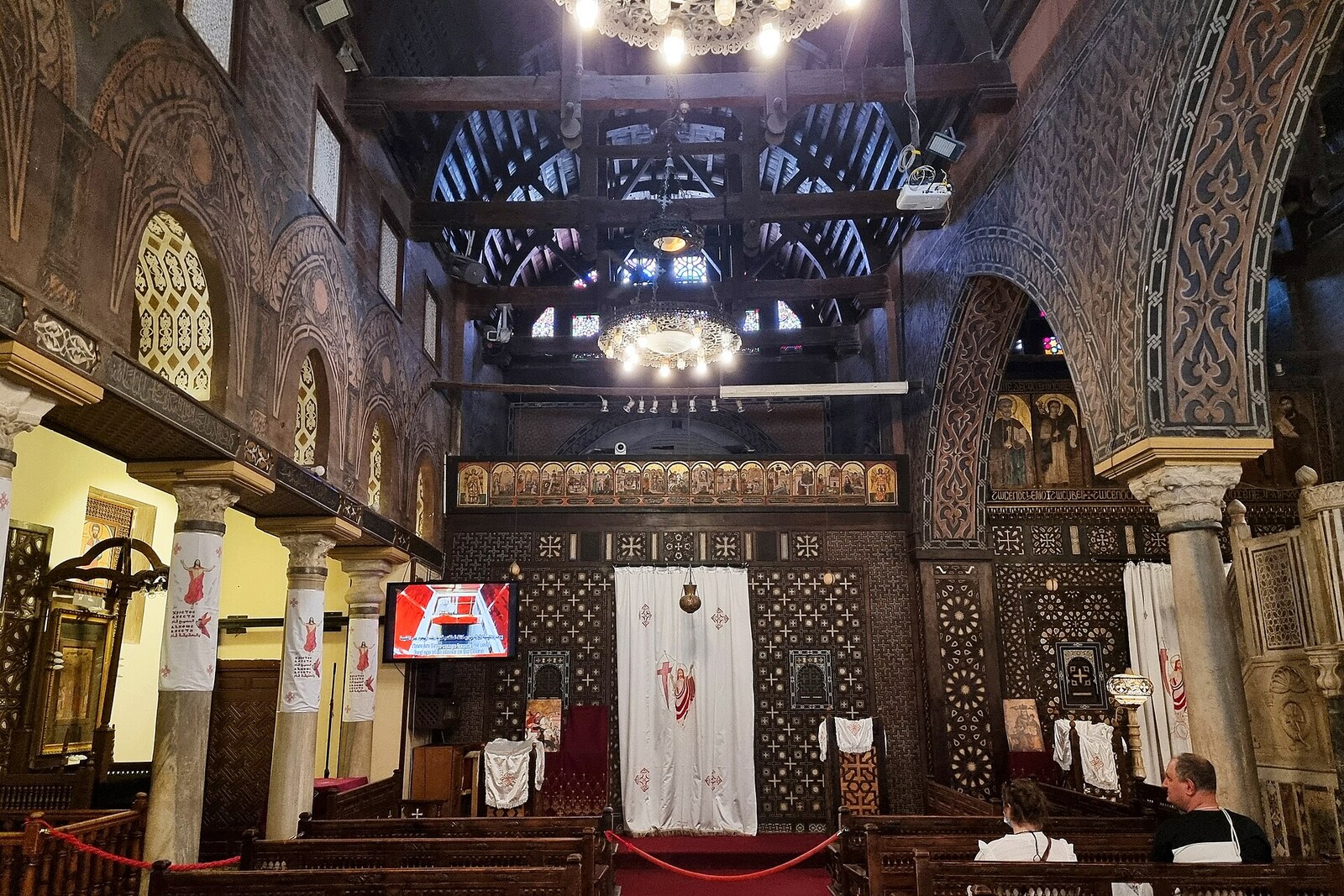 The Hanging Church with a white facade and arches, raised above ancient walls