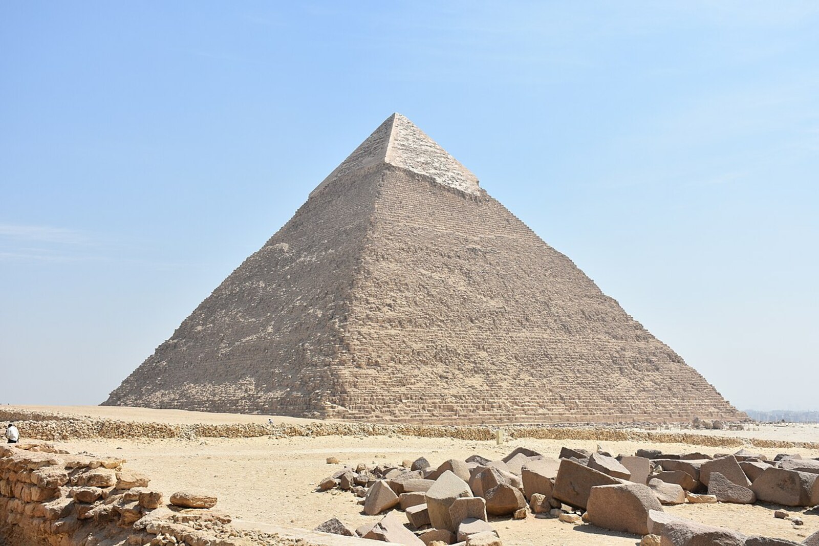The Pyramid of Khafre on the Giza Plateau beneath a blue sky.