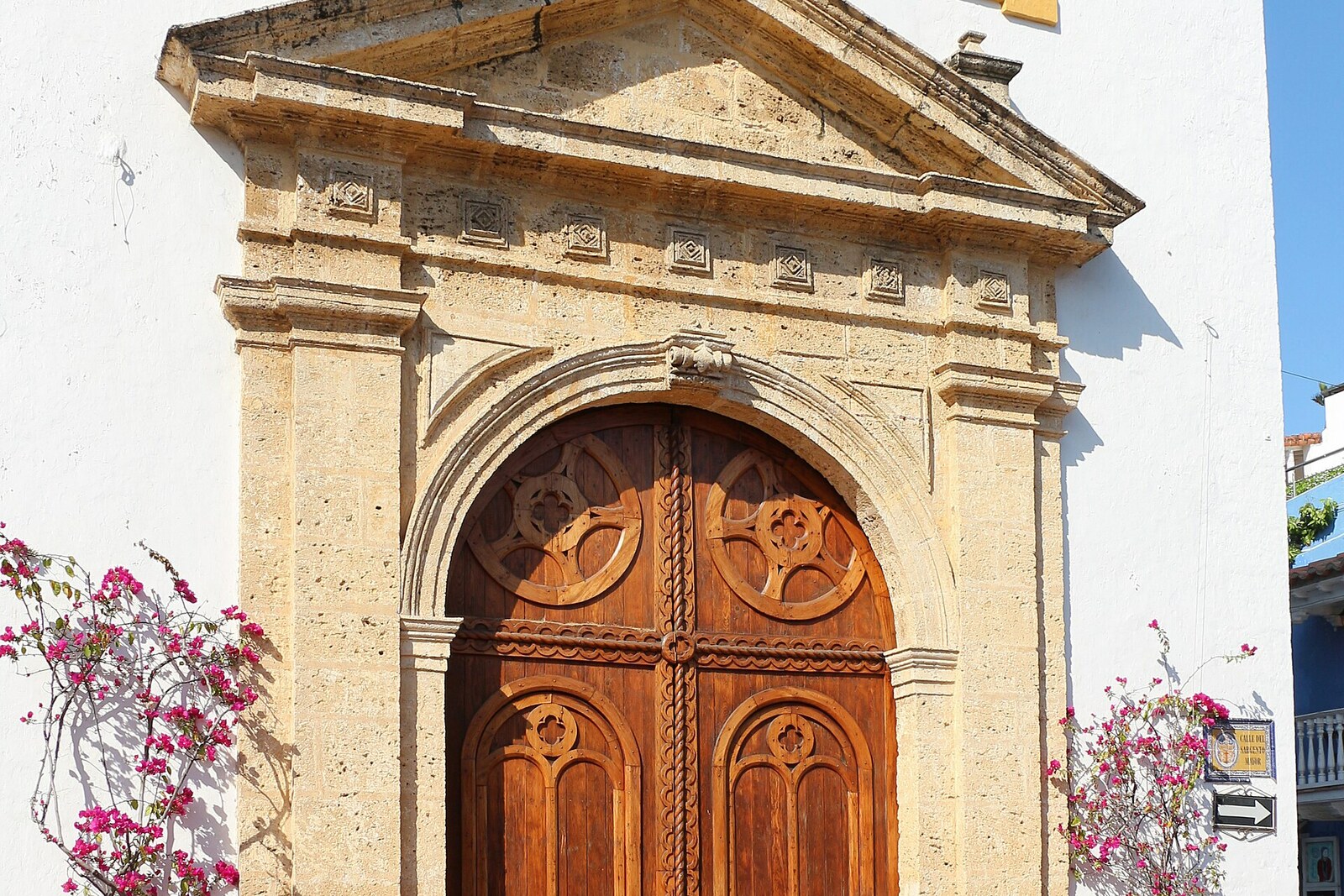 Yellow facade and bell tower of the Church of Santo Toribio de Mogrovejo in Cartagena
