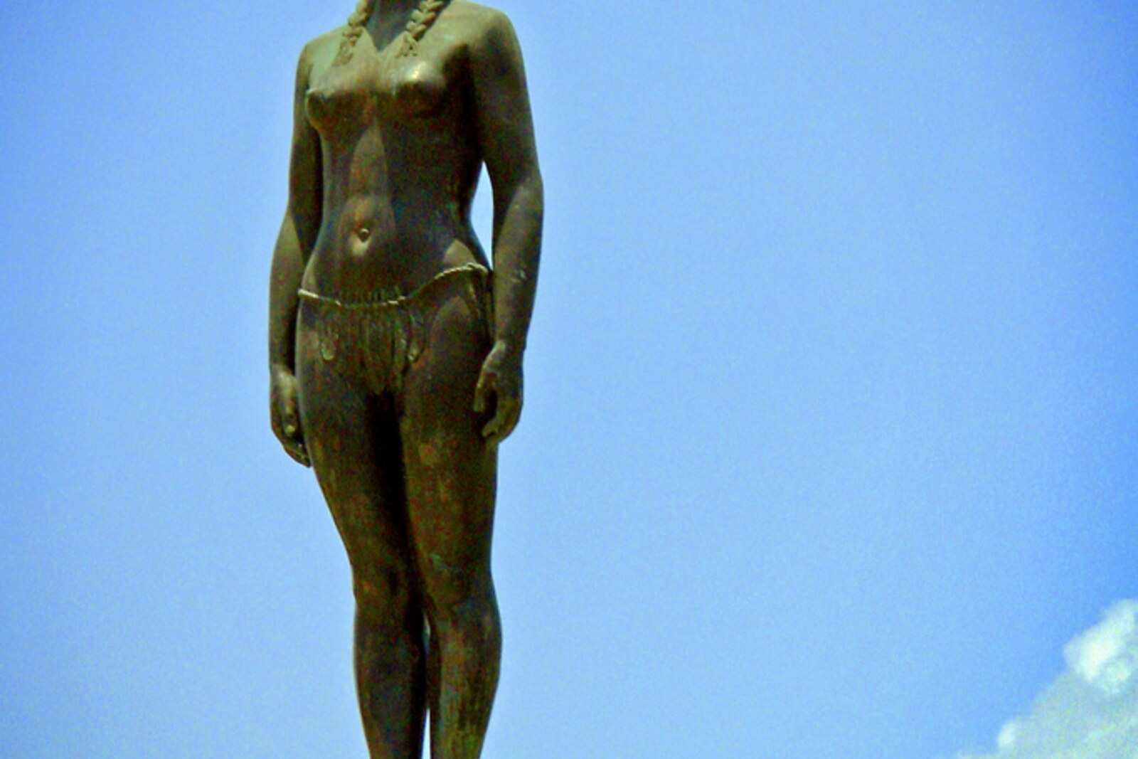 Bronze statue of India Catalina against a blue sky