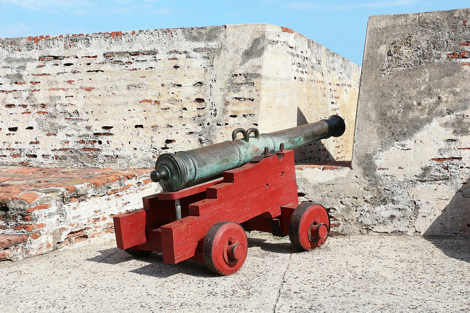 An old cannon on a stone platform overlooking the city