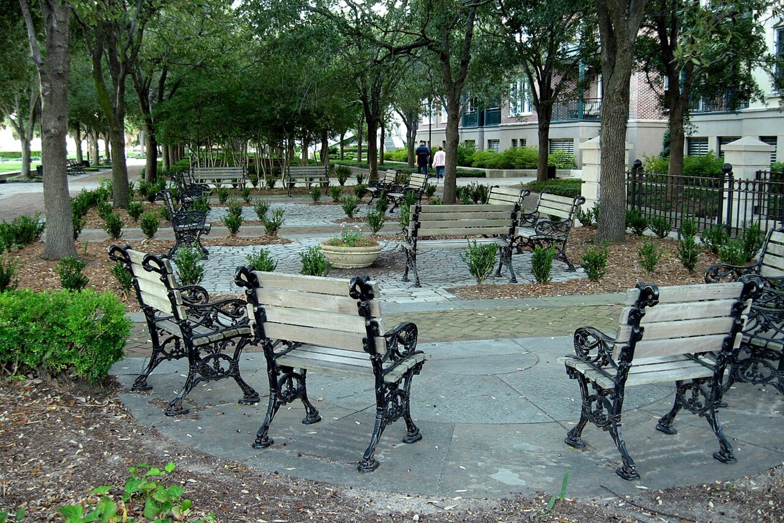 Benches in the shade of trees at Joe Riley Waterfront Park, beside the former Gadsden's Wharf.