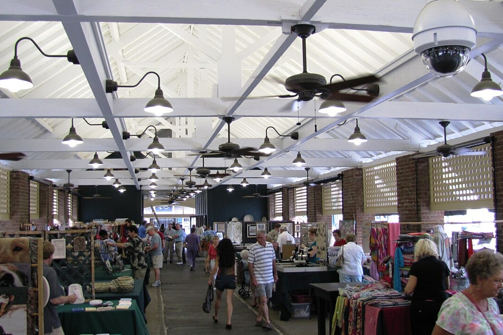 The pavilion of the old Charleston City Market with vendor stalls and wooden columns.