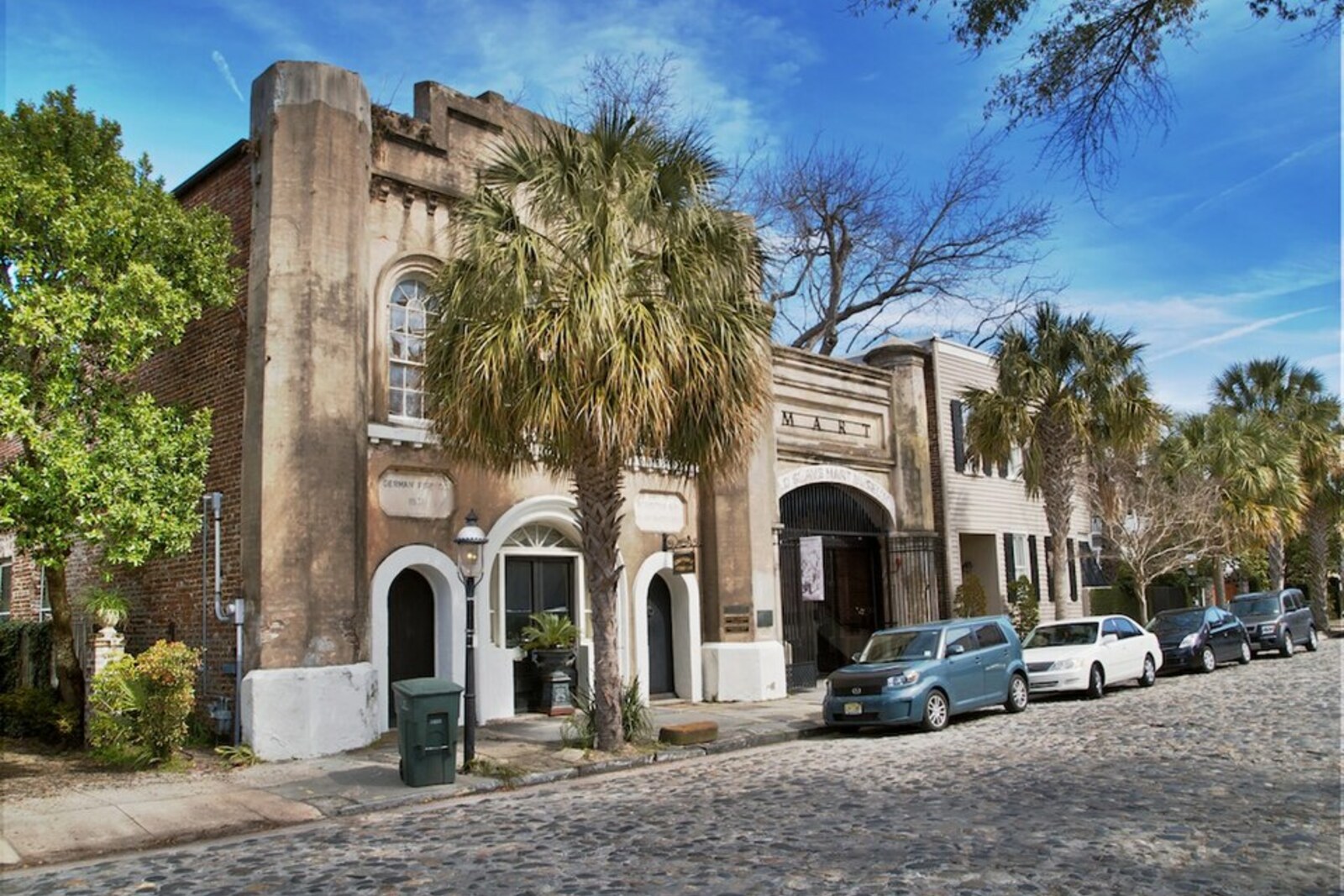 The facade of the Old Slave Mart with its arched entrance and columns.