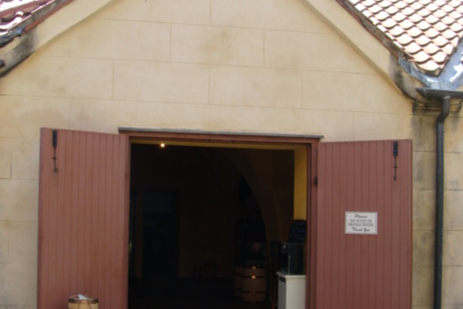 The Powder Magazine, a small building with white walls and a pyramidal roof.