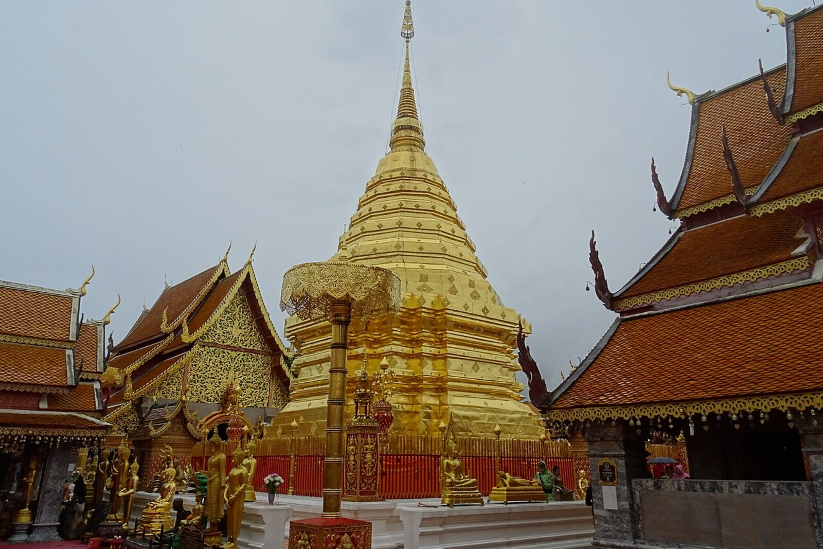 The shining golden chedi of Wat Phra That Doi Suthep against a blue sky