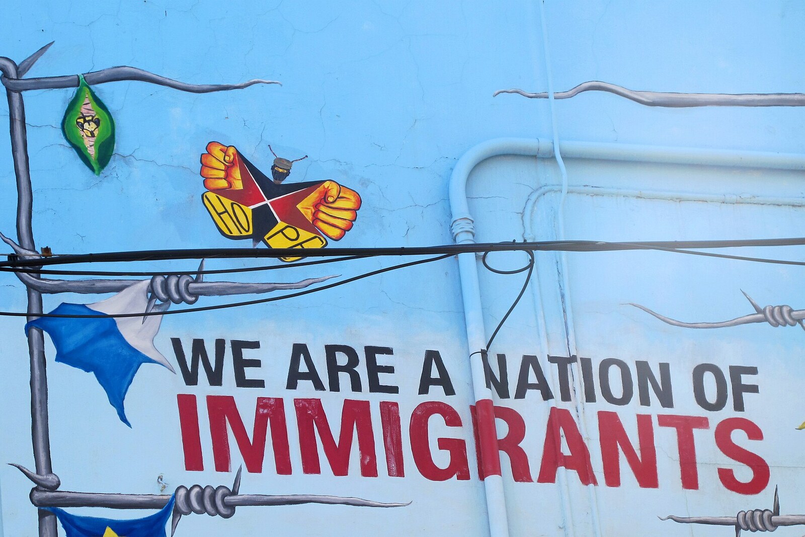 The text mural We Are a Nation of Immigrants in Pilsen.