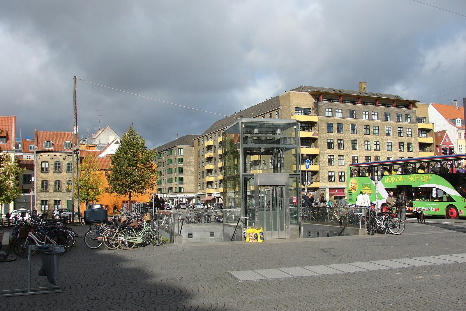 Christianshavns Torv square with the white Layer Cake House and pedestrians.
