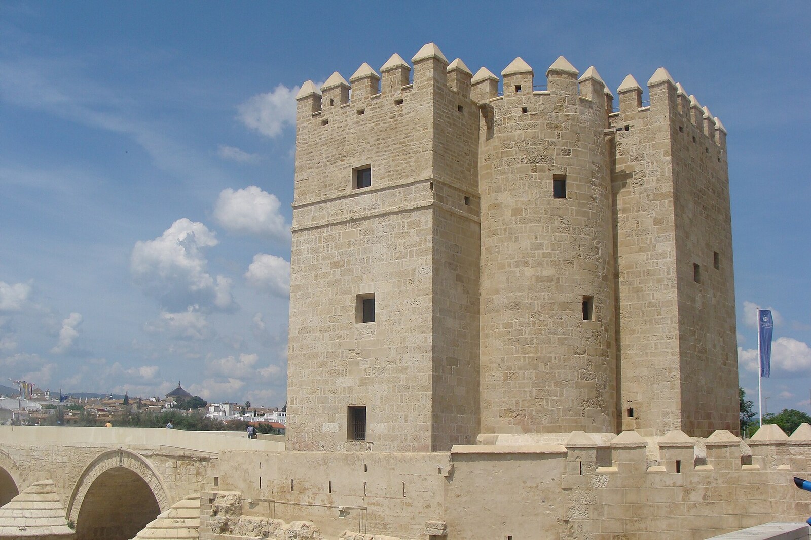 Calahorra Tower with battlements and an adjoining arch of the Roman Bridge.