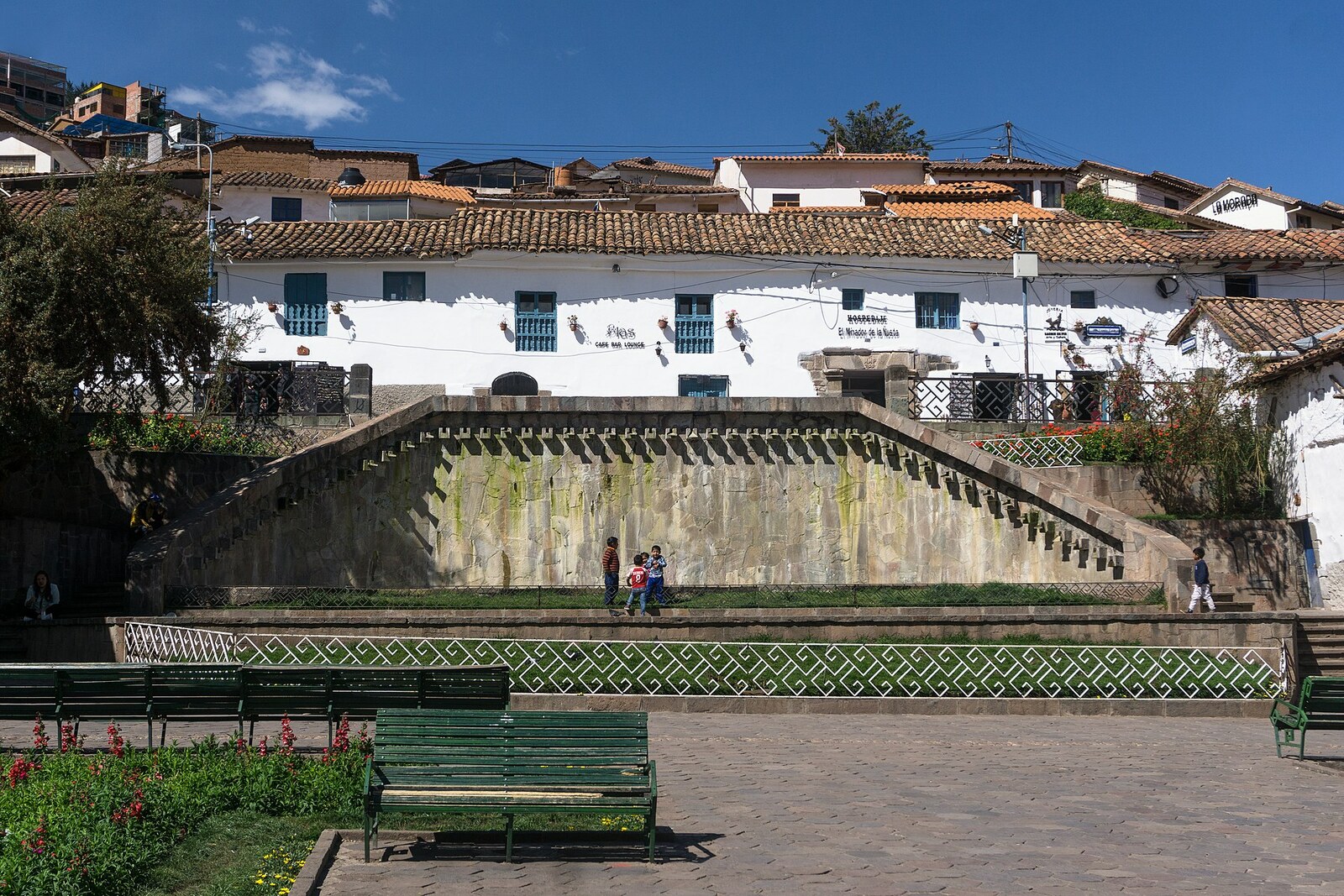 Plazoleta de San Blas with a fountain, trees, and façades of the artisan district