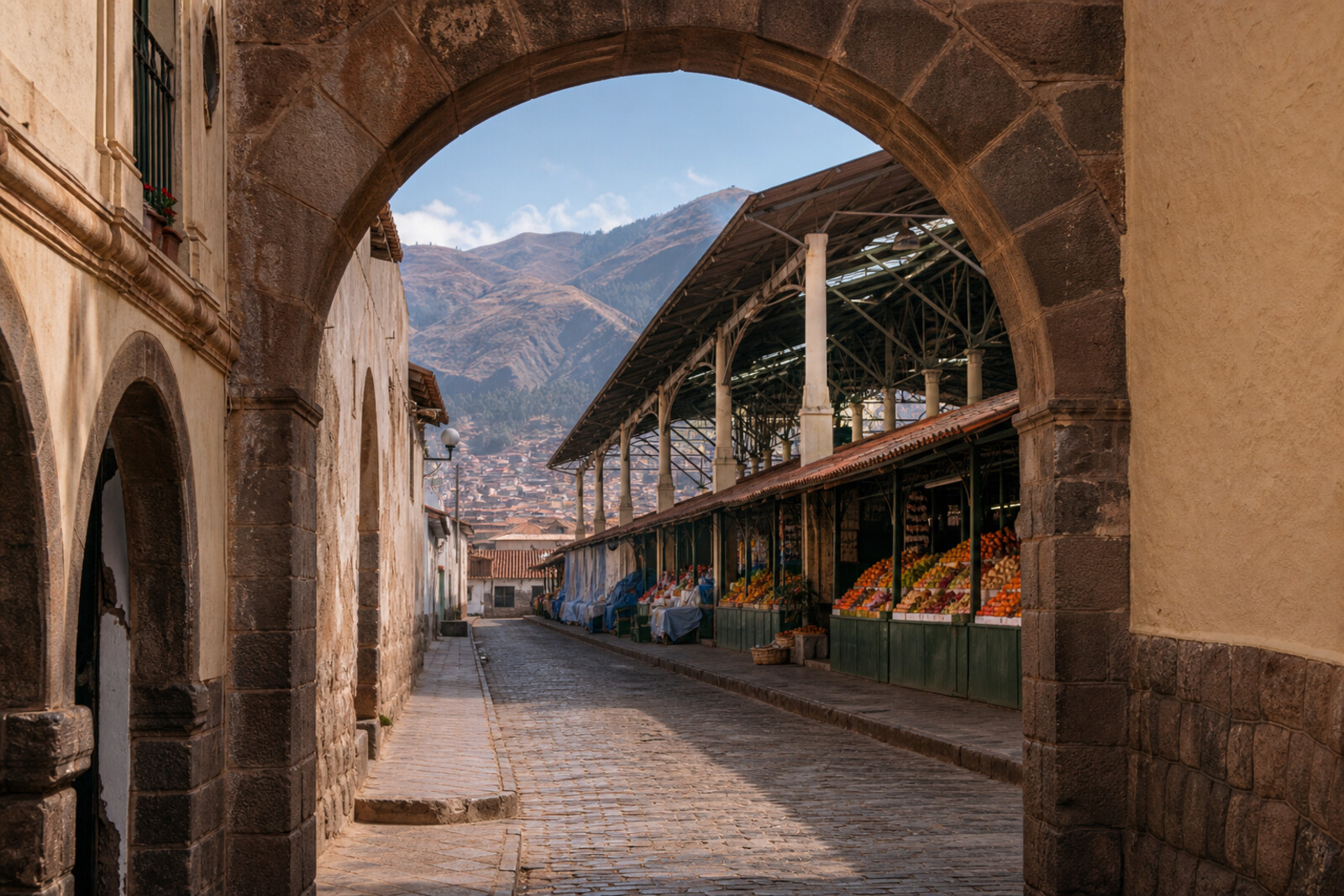A colonial arch and covered market in the San Pedro and Santa Clara quarter, with mountains on the horizon.