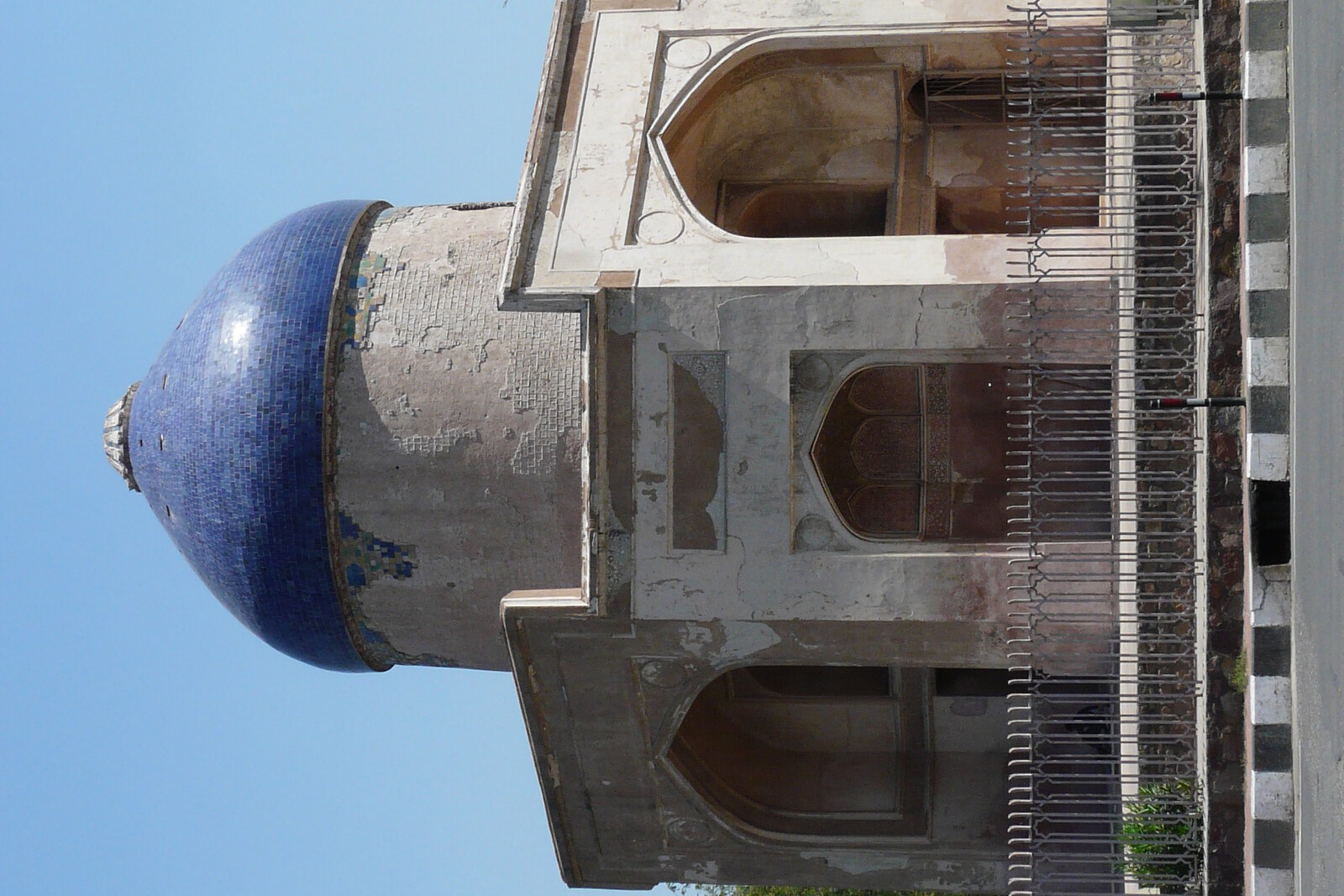 The octagonal Sabz Burj with a blue dome on a green lawn.