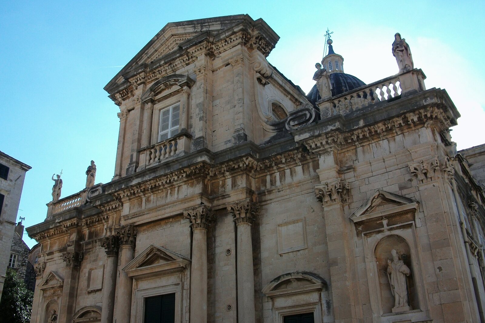 Façade of Dubrovnik Cathedral with Baroque details and a dome.