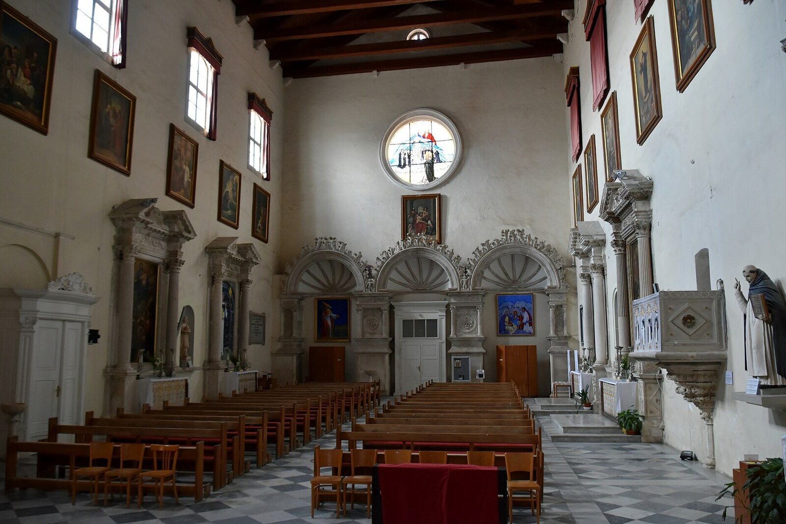 Entrance to the Dominican Monastery with Gothic columns and arches.