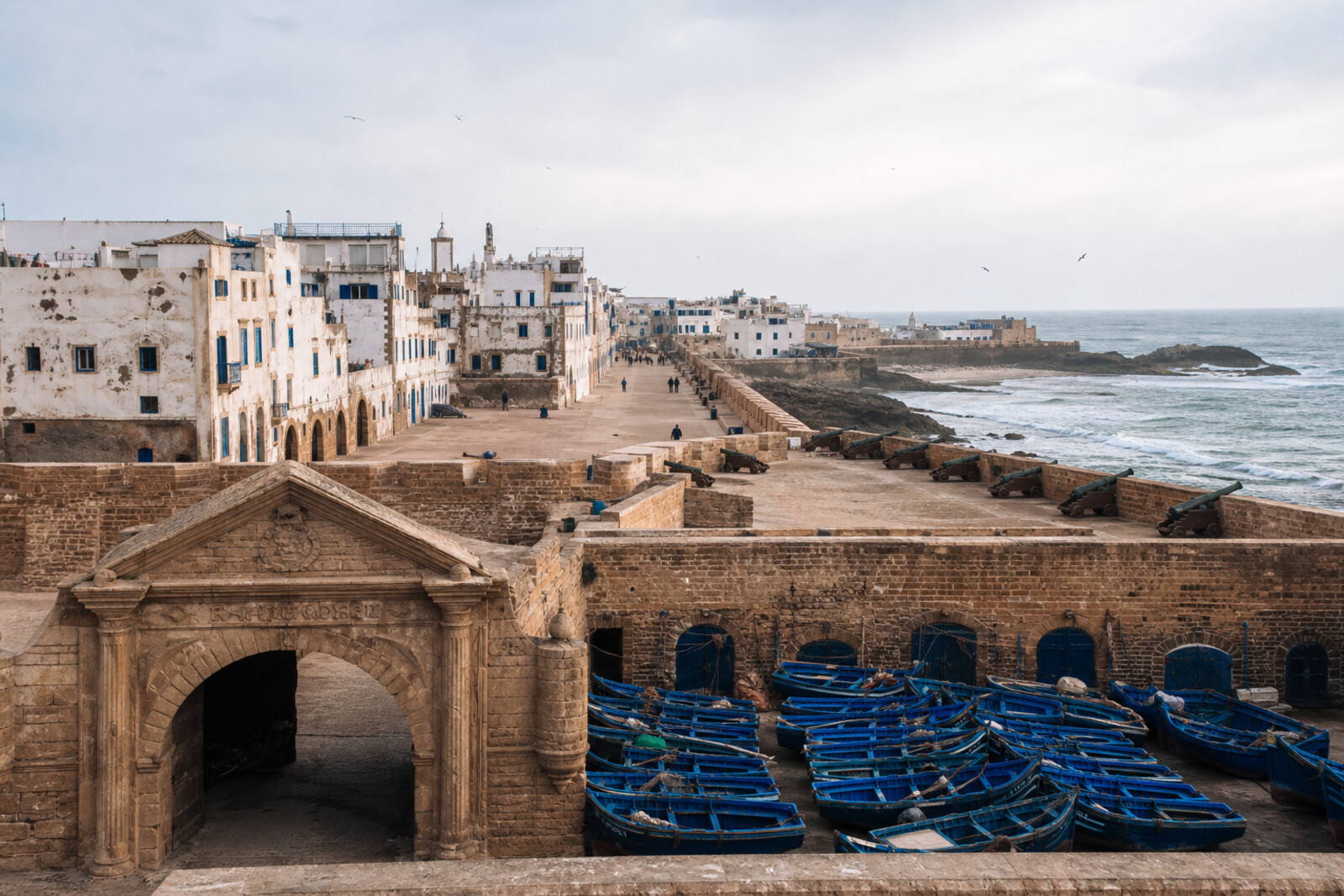 Bab el-Marsa, port fortifications, fishing boats, and the straight axis of Essaouira's medina.