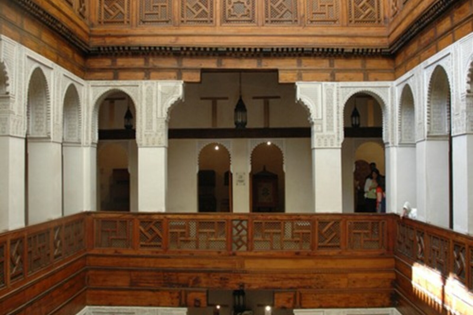 Interior courtyard of the Nejjarine Funduq: three-story wooden galleries surround a mosaic fountain