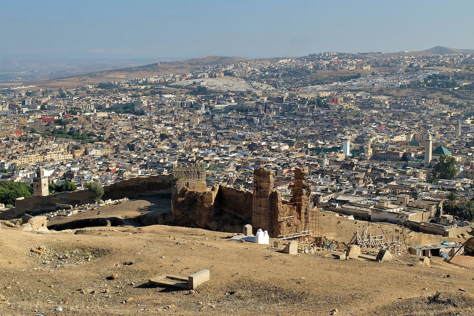 Ancient walls of Fez with towers stretching along a hillside